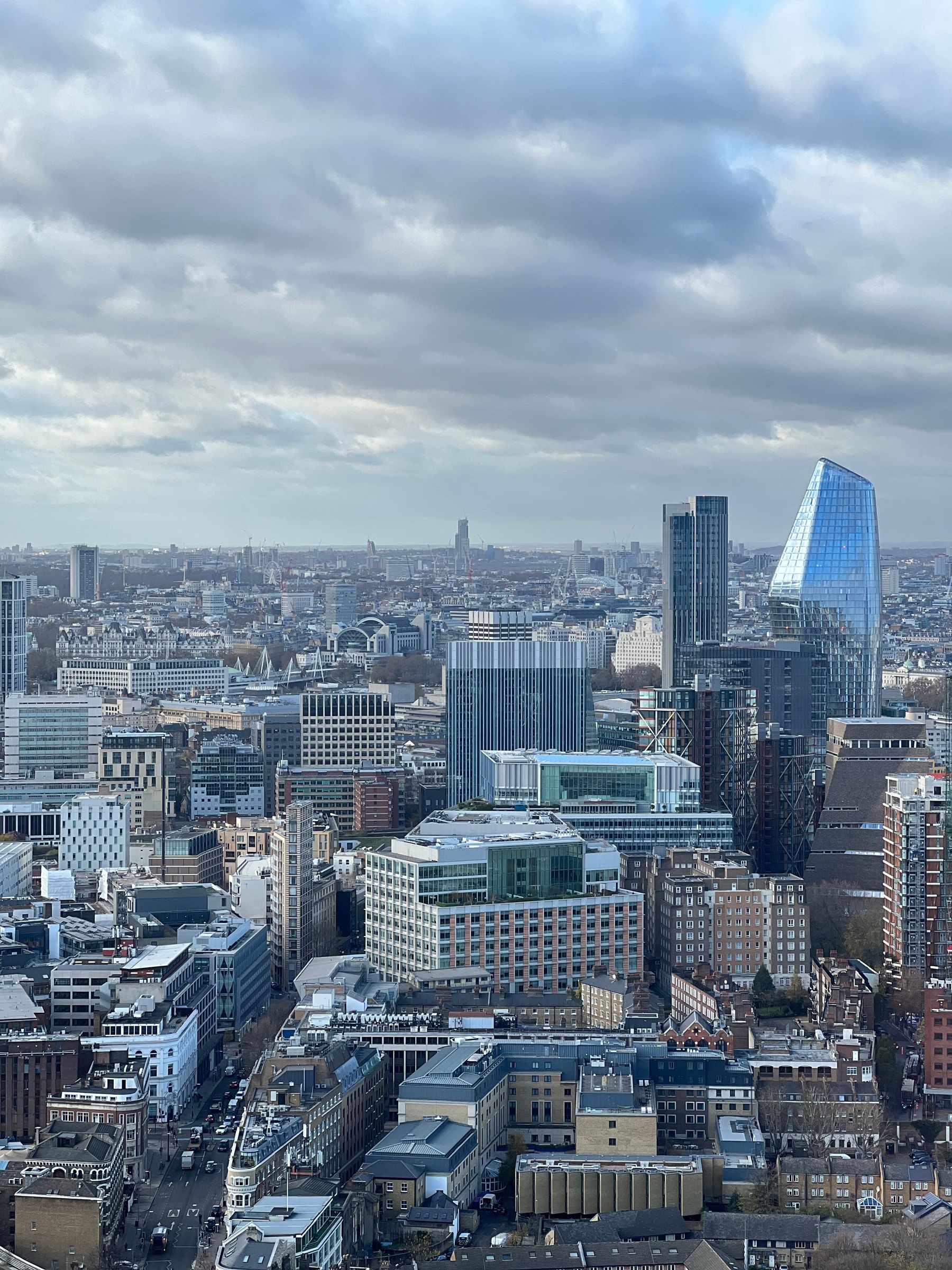 Aerial view of modern and classic London architecture under cloud